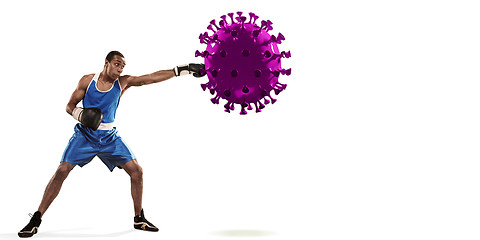 Image showing Professional sportsman kicking, punching coronavirus model - fight the desease, flyer