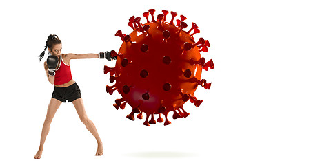 Image showing Professional sportswoman kicking, punching coronavirus model - fight the desease, flyer