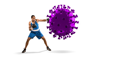 Image showing Professional sportsman kicking, punching coronavirus model - fight the desease, flyer