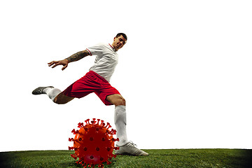 Image showing Football or soccer player kicking, punching model of coronavirus - fighting with epidemic concept