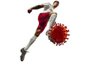 Image showing Football or soccer player kicking, punching model of coronavirus - fighting with epidemic concept