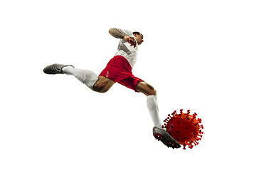 Image showing Football or soccer player kicking, punching model of coronavirus - fighting with epidemic concept