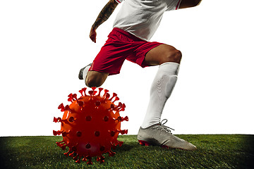 Image showing Football or soccer player kicking, punching model of coronavirus - fighting with epidemic concept