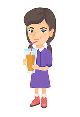 Image showing Girl drinking orange juice through a straw.