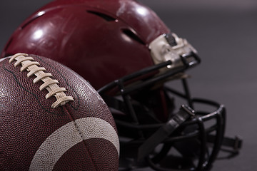 Image showing american football and helmets isolated on gray