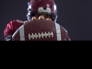 Image showing american football player showing football to camera