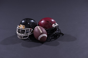 Image showing american football and helmets isolated on gray