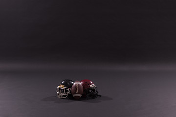 Image showing american football and helmets isolated on gray