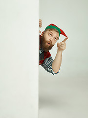 Image showing friendly man dressed like a funny gnome posing on an isolated gray background