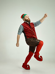 Image showing friendly man dressed like a funny gnome posing on an isolated gray background