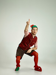 Image showing friendly man dressed like a funny gnome posing on an isolated gray background