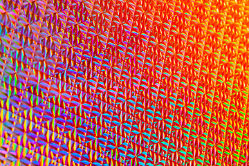 Image showing Texture of red foil with holographic effect. Christmas background.