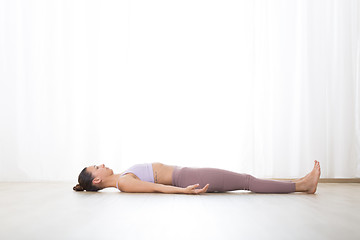 Image showing Portrait of gorgeous active sporty young woman practicing breathing exercises in yoga studio. Healthy active lifestyle, working out indoors in gym