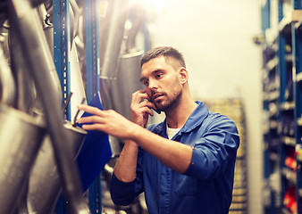 Image showing auto mechanic with clipboard at car workshop