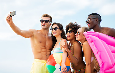 Image showing happy friends taking selfie on summer beach