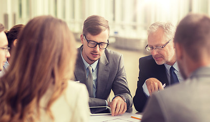 Image showing architects with blueprint and tablet pc at office