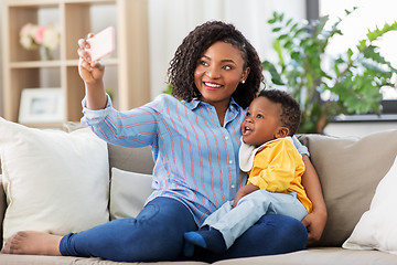 Image showing african mother with baby son taking selfie at home