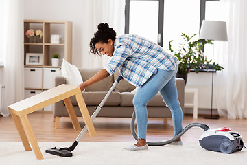 Image showing woman or housewife with vacuum cleaner at home