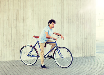 Image showing young hipster man riding fixed gear bike