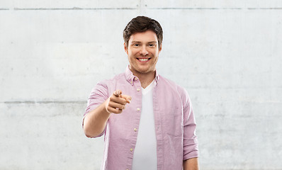 Image showing smiling man pointing fingers at you