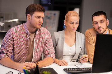 Image showing business team with computer working late at office