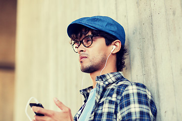 Image showing man with earphones and smartphone listening music