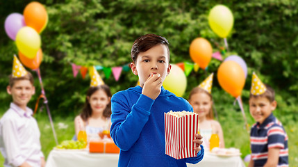 Image showing boy eating popcorn at birthday party