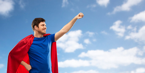 Image showing man in red superhero cape over sky background