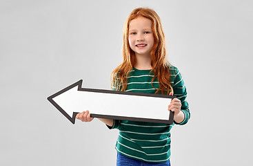 Image showing smiling red haired girl with arrow showing to left