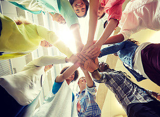 Image showing group of international students with hands on top