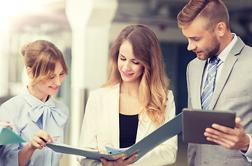 Image showing business team with tablet pc and folders at office