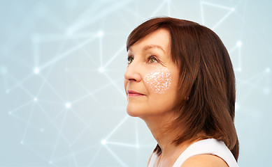 Image showing senior woman with low poly grid on her cheek