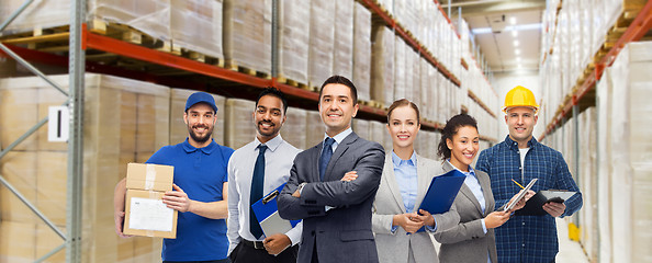 Image showing group of business people and warehouse workers