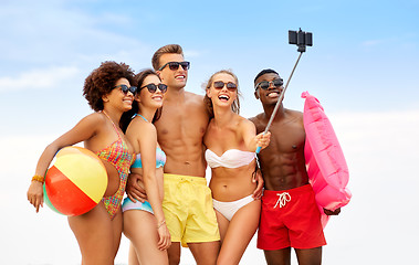 Image showing happy friends taking selfie on summer beach