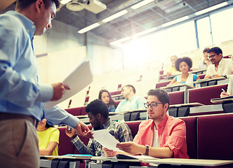 Image showing teacher giving tests to students at lecture