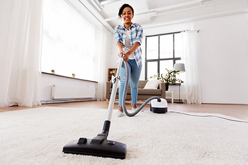 Image showing woman or housewife with vacuum cleaner at home