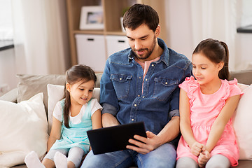 Image showing happy father and daughters with tablet pc at home