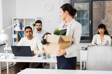 Image showing female office worker with box of personal stuff