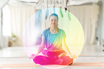 Image showing woman meditating in lotus pose at yoga studio