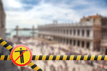 Image showing Crossing fencing lines and warning sign with crossed out man on the blurred background of Doge\'s Palace in Venice, Italy.