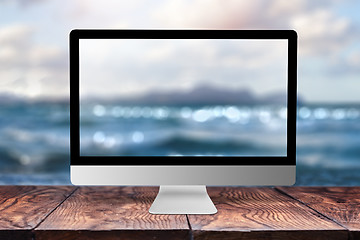 Image showing Computer display with blurred sea background.