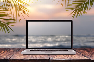 Image showing Laptop screen with blurred sea background.