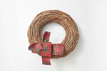 Image showing Handcraft round wreath from twigs on a white background.