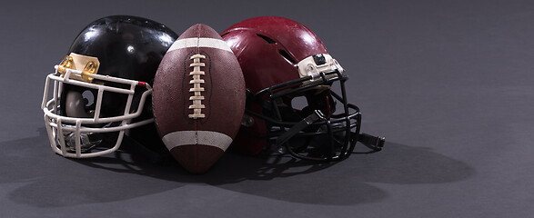 Image showing american football and helmets isolated on gray