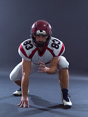 Image showing American football player getting ready before starting