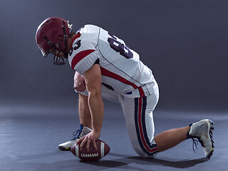 Image showing American football player getting ready before starting