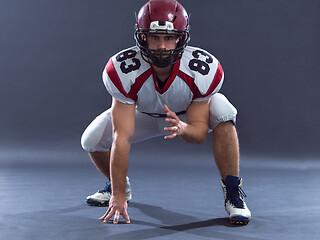 Image showing American football player getting ready before starting