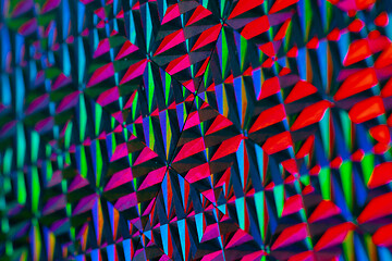 Image showing Texture of red foil with holographic effect. Christmas background.