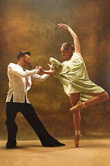 Image showing Flexible young modern dance couple posing in studio.