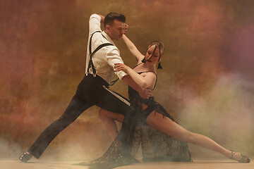 Image showing Flexible young modern dance couple posing in studio.